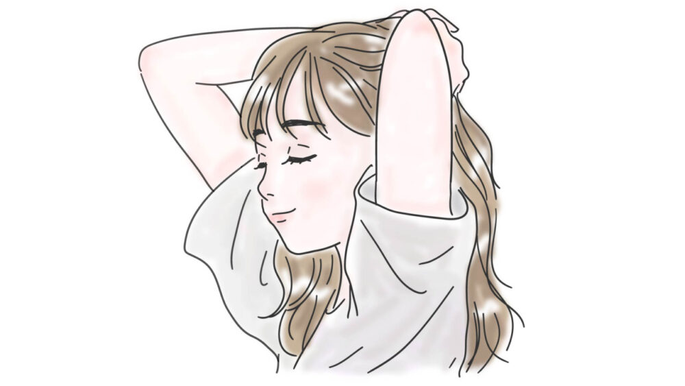 目を瞑り両手を頭の後ろに回す女性